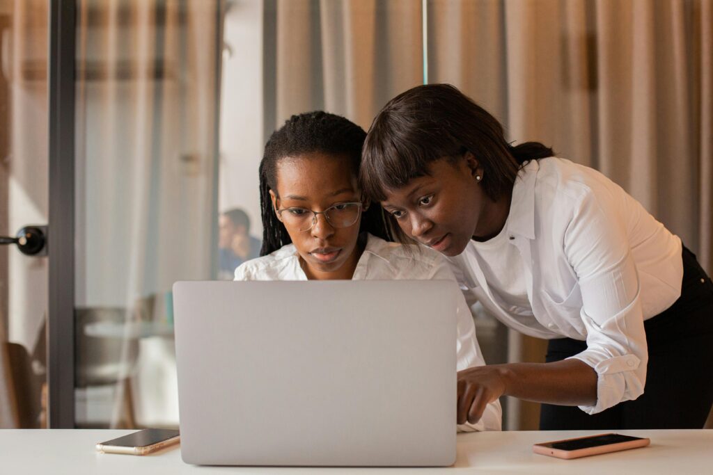 pexels-photo-9490629-9490629 Two African American women working together on a laptop indoors, showcasing teamwork and collaboration.
